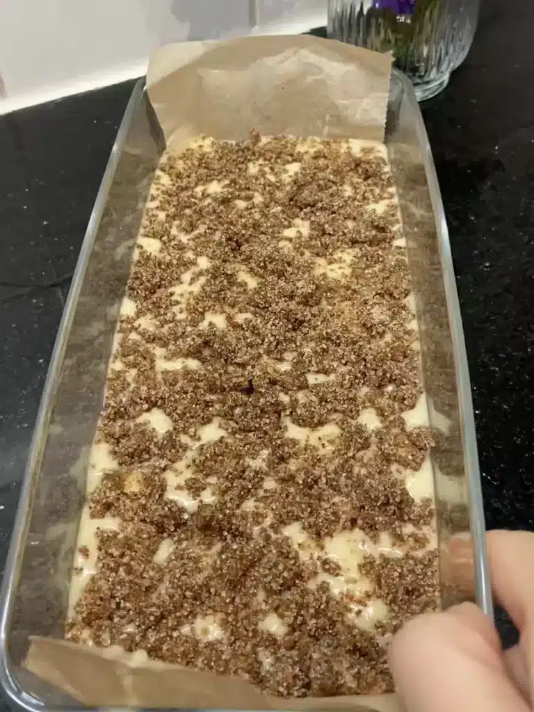 Batter with peaches being poured into pan