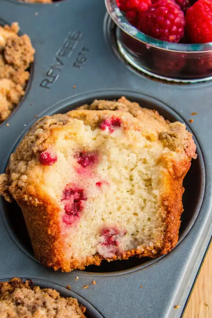Lemon raspberry muffins with streusel on wooden table