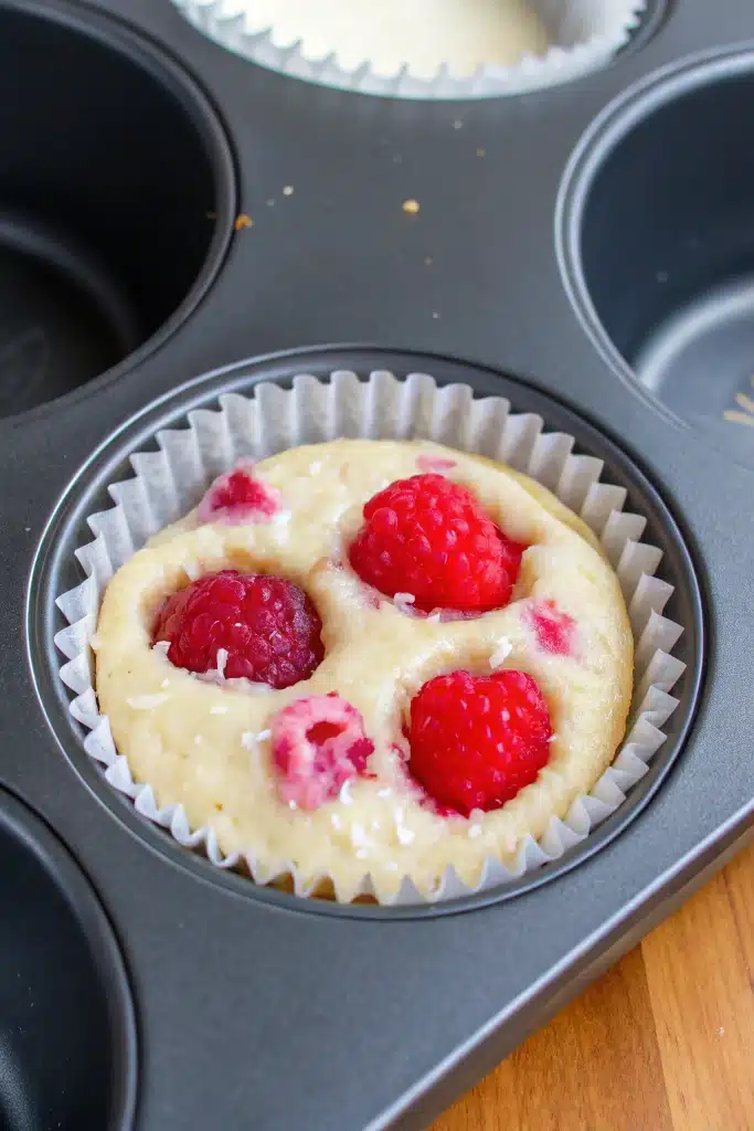 Lemon raspberry muffins with streusel on wooden table