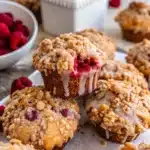 Lemon raspberry muffins with streusel on wooden table